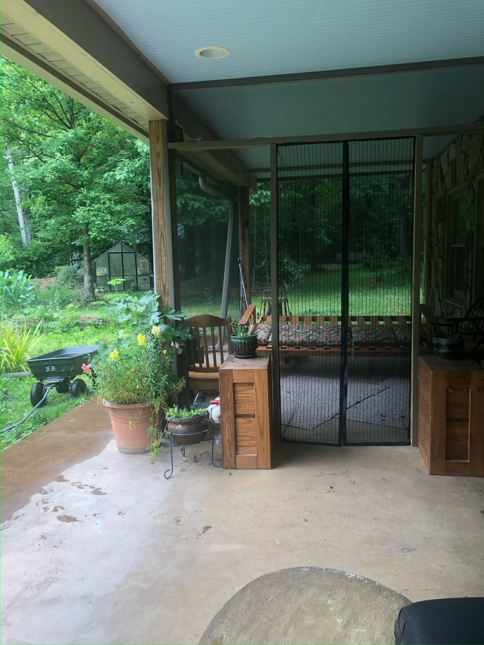 Screened-in porch on the garden level, under the porch with the huge Solar array