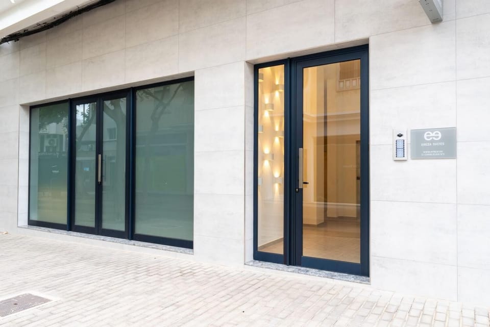 A sleek modern suite entrance with stylish signage and a clean city-street setting.