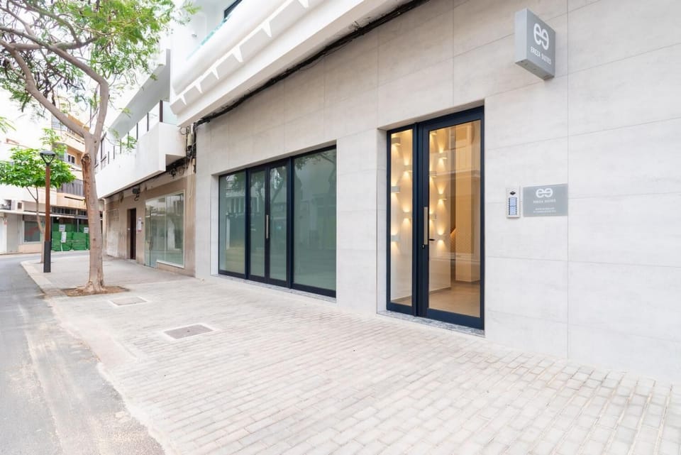 A sleek modern suite entrance with stylish signage and a clean city-street setting.