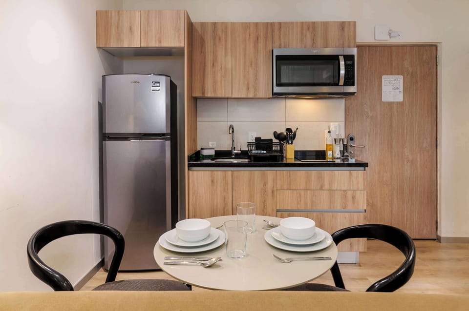 Dining area next to a fully equipped kitchen.
