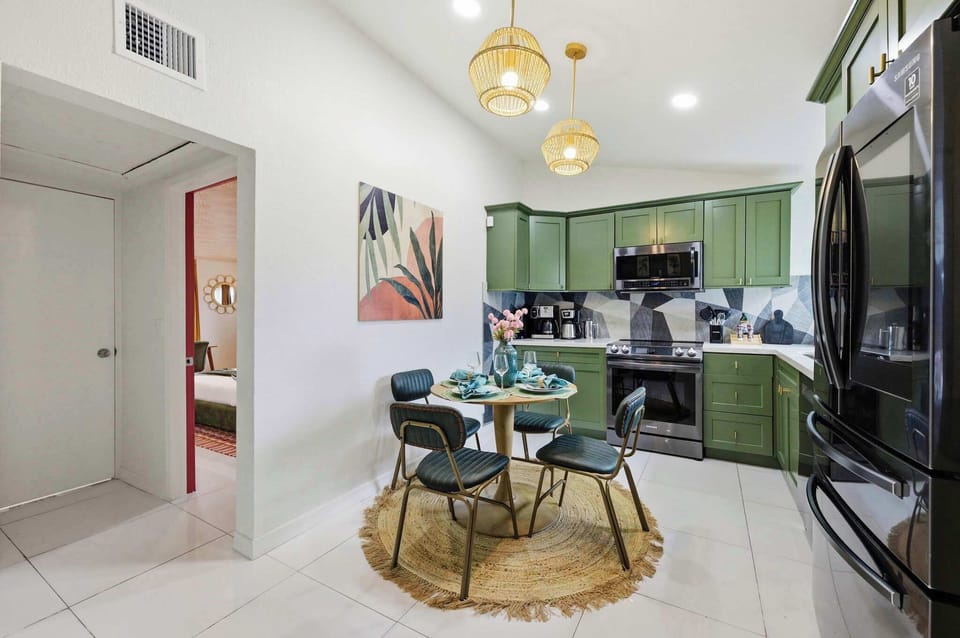 Cook, dine & linger in this cheerful kitchen space! Bold green cabinetry, modern appliances & a cozy dining nook mean you've got everything for easy, delicious meals in. 