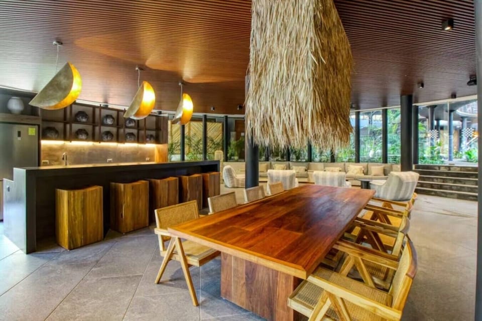 Beautiful open-concept dining and social area designed with warm wood finishes and authentic tropical charm.