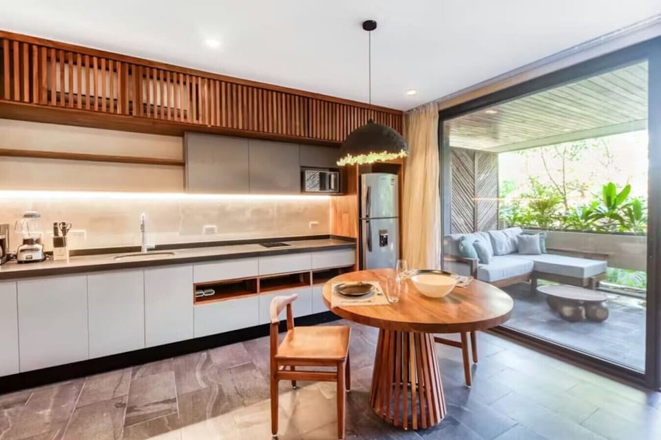 Chic dining and kitchen area with natural textures, modern finishes, and a cozy space to enjoy breakfast or dinner together.