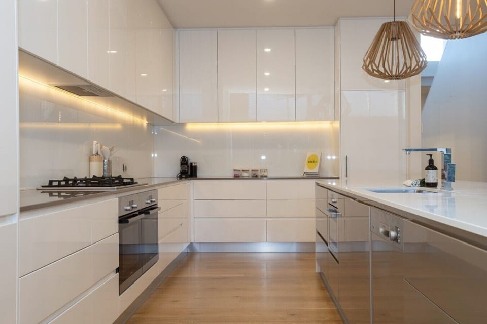 Gas cooktop, under-cabinet lighting and stone benchtops