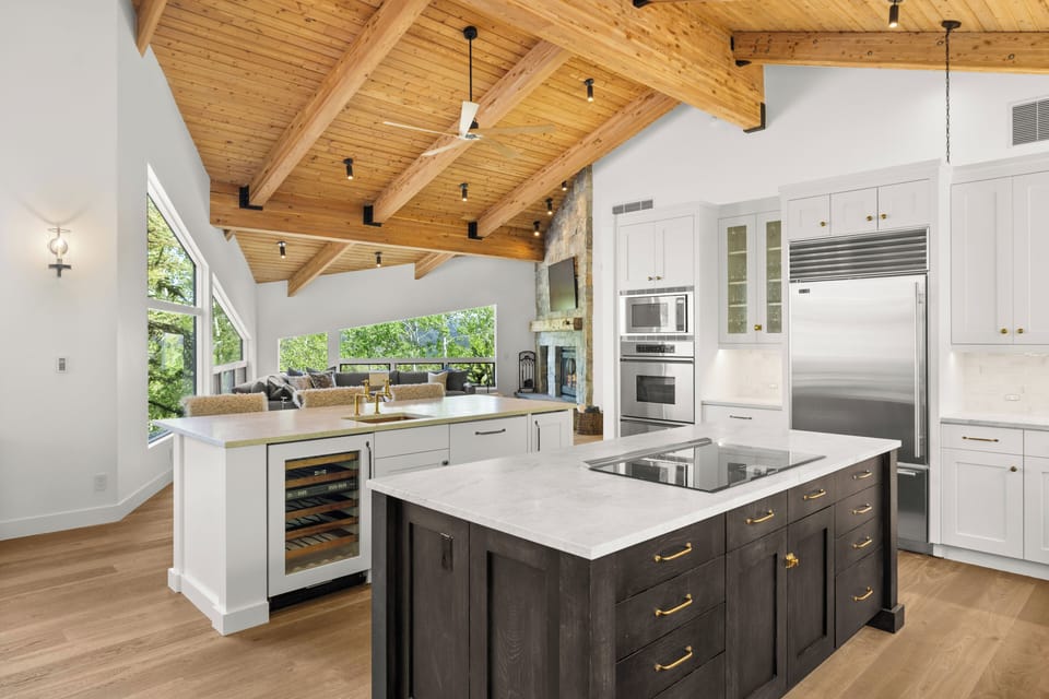 Spacious, fully-equipped chef's kitchen with double ovens, two islands, and views of the Snowmass wilderness and valley below.