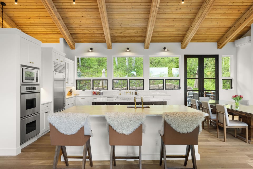 Spacious, fully-equipped chef's kitchen with double ovens, two islands, and views of the Snowmass wilderness and valley below.