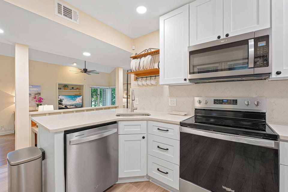 Quartz countertops, stainless steel appliances, abundant cabinetry, and generous prep space make cooking a pleasure.