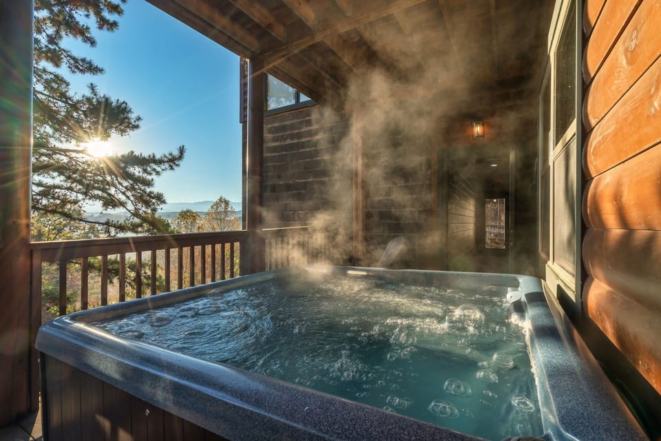 Private outdoor hot tub with Smoky Mountain views, covered deck seating, relaxing spa experience, and peaceful cabin retreat in Sevierville Tennessee.