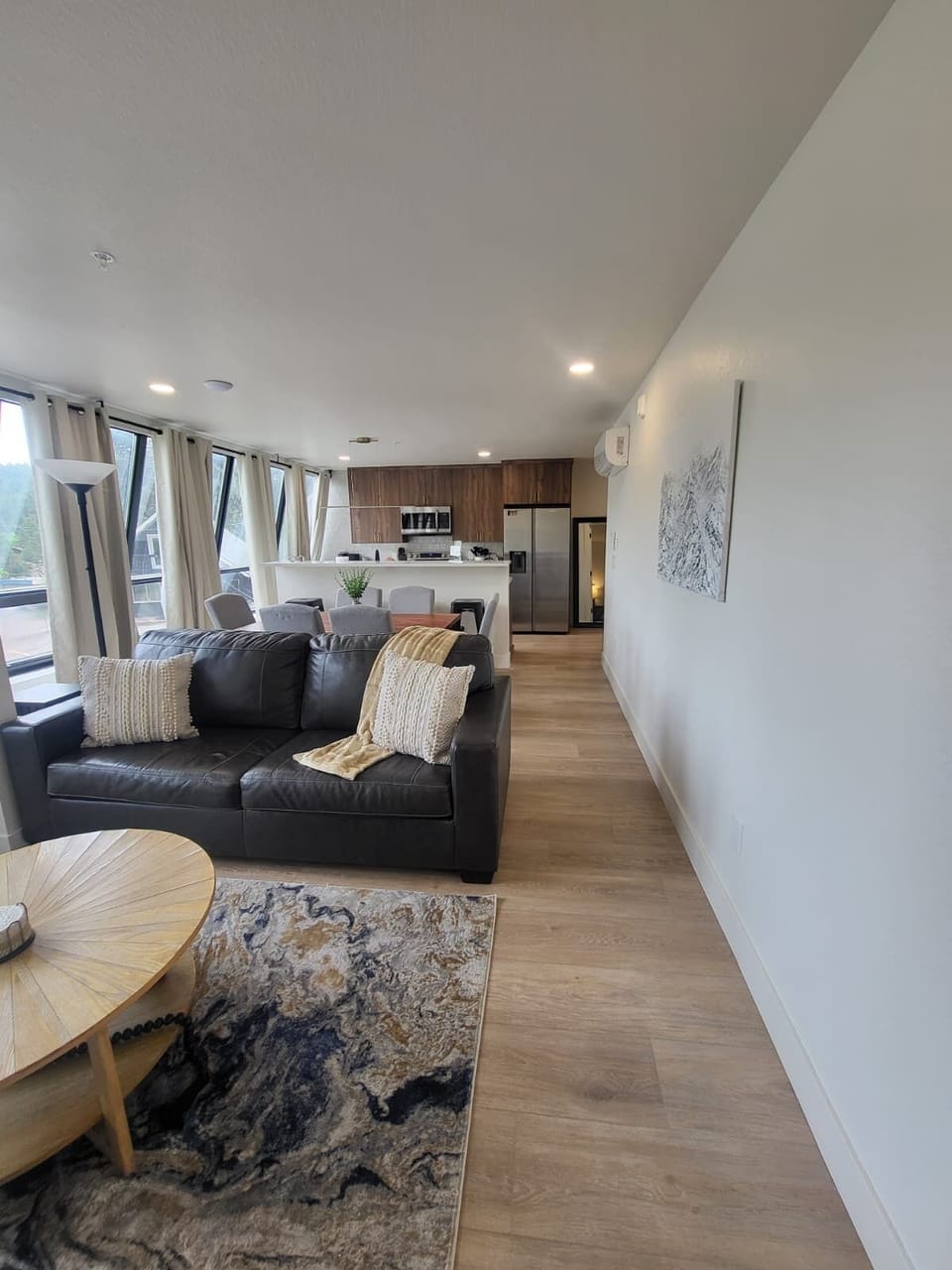 The living room, dining room, and kitchen have an open concept in this well appointed condo! 