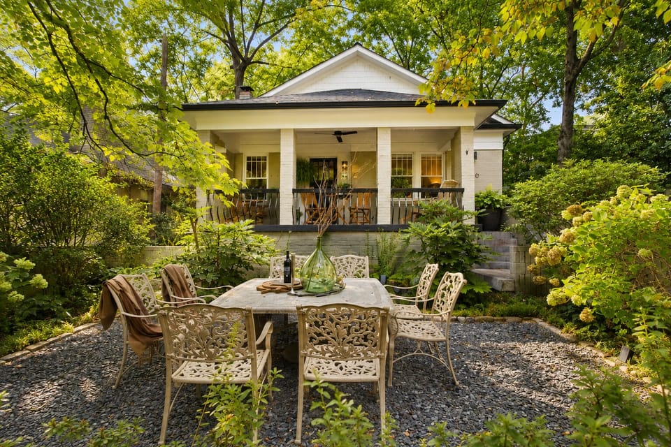 Tuscan Courtyard. A ultra-rare private garden oasis featuring manicured landscaping and a stone dining table with formal seating for 8.