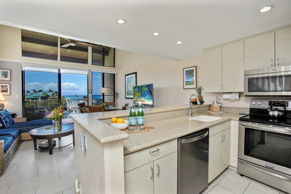 This open kitchen features a spacious island, full-size fridge, and clean cabinetry for effortless island-style living     NAP-C31