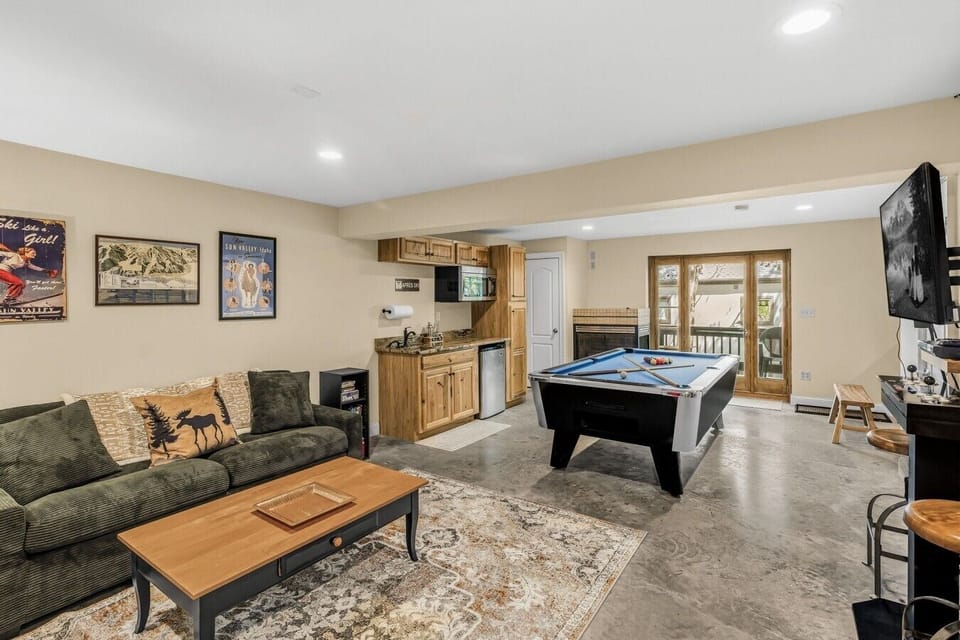 Let the fun begin in the basement game room with a pool table, lounge seating, TV, wet bar, and plenty of space for family game night. 🎱✨