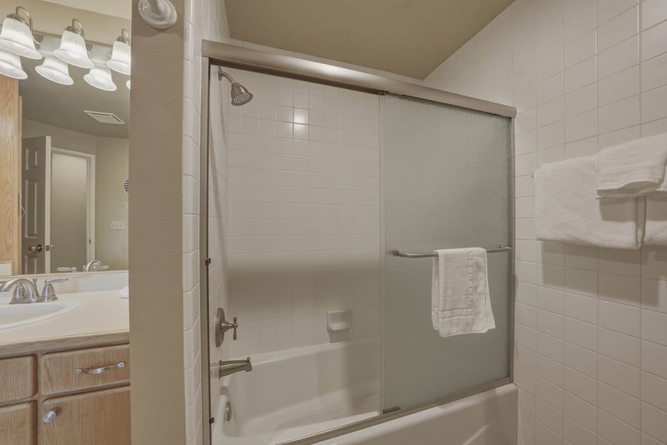 Shared ensuite with shower/tub combo, and laundry area, accessible from the living area 