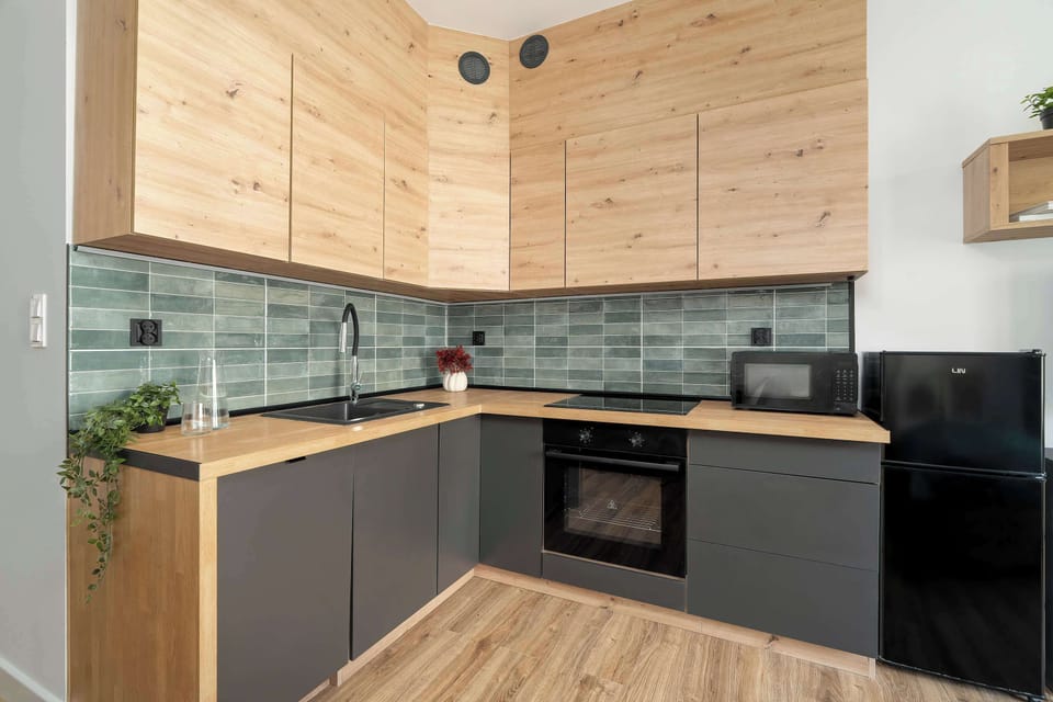 Fully equipped kitchenette with modern appliances and ample cabinet space.