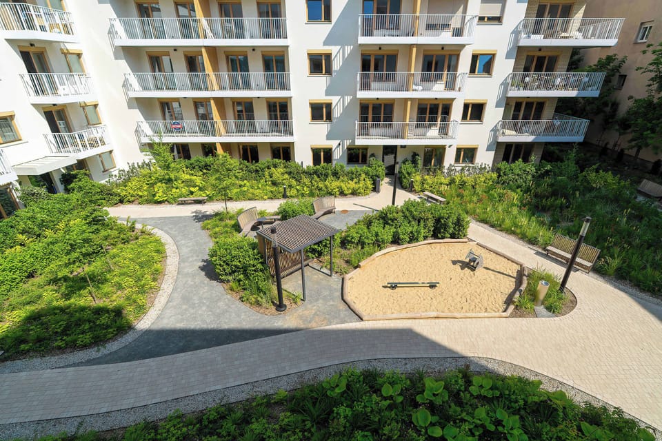 Landscaped courtyard with green spaces and recreational areas for residents.