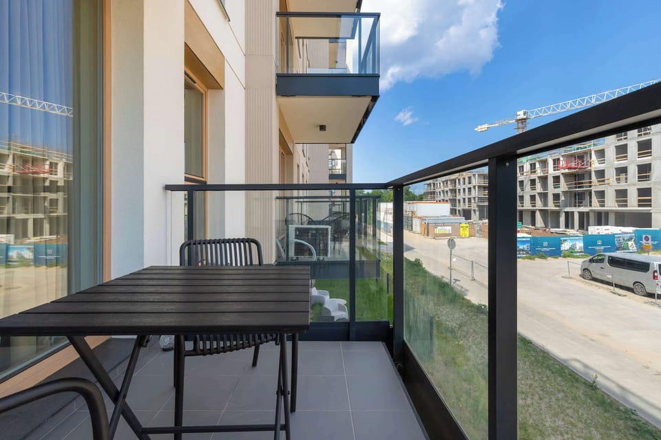 Private balcony with outdoor seating, perfect for relaxing outdoors.