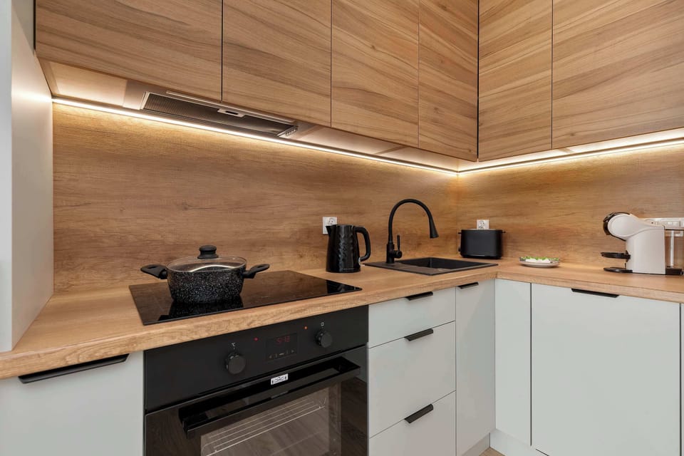 Fully equipped kitchenette with modern appliances and ample workspace for meal preparation.