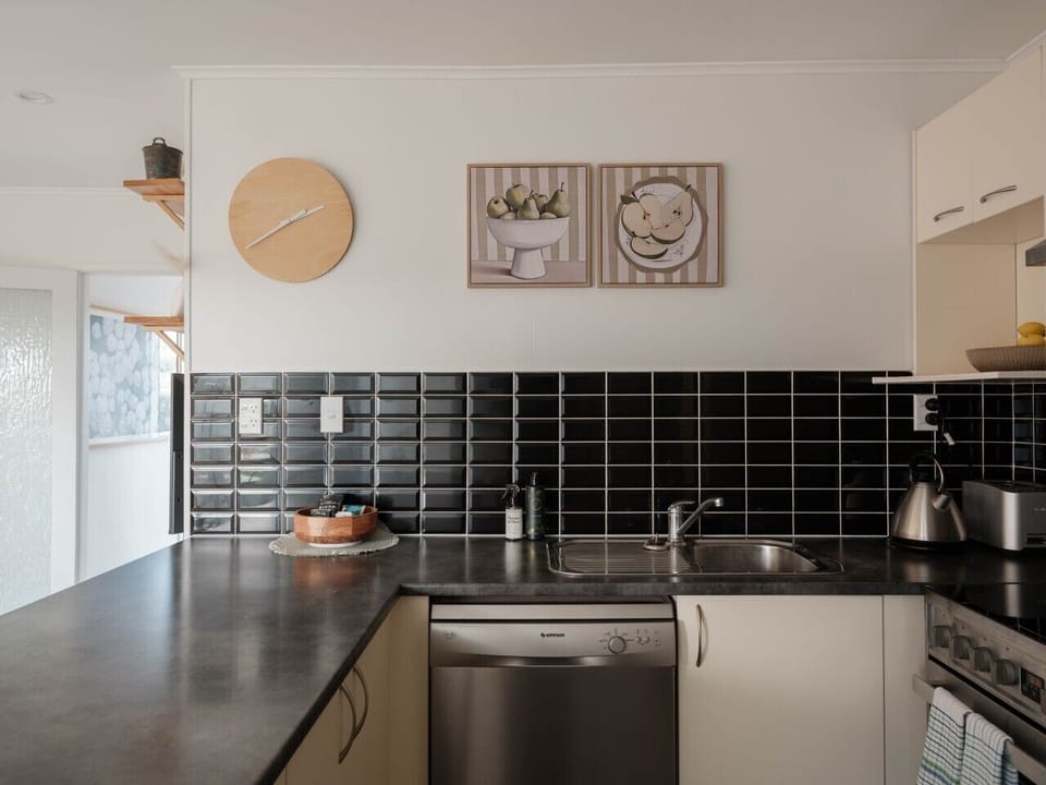Kitchen with dishwasher, microwave, toaster, oven, stove and fridge
