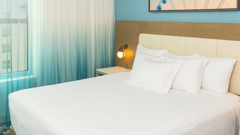 Guest bedroom features a king bed and a TV.