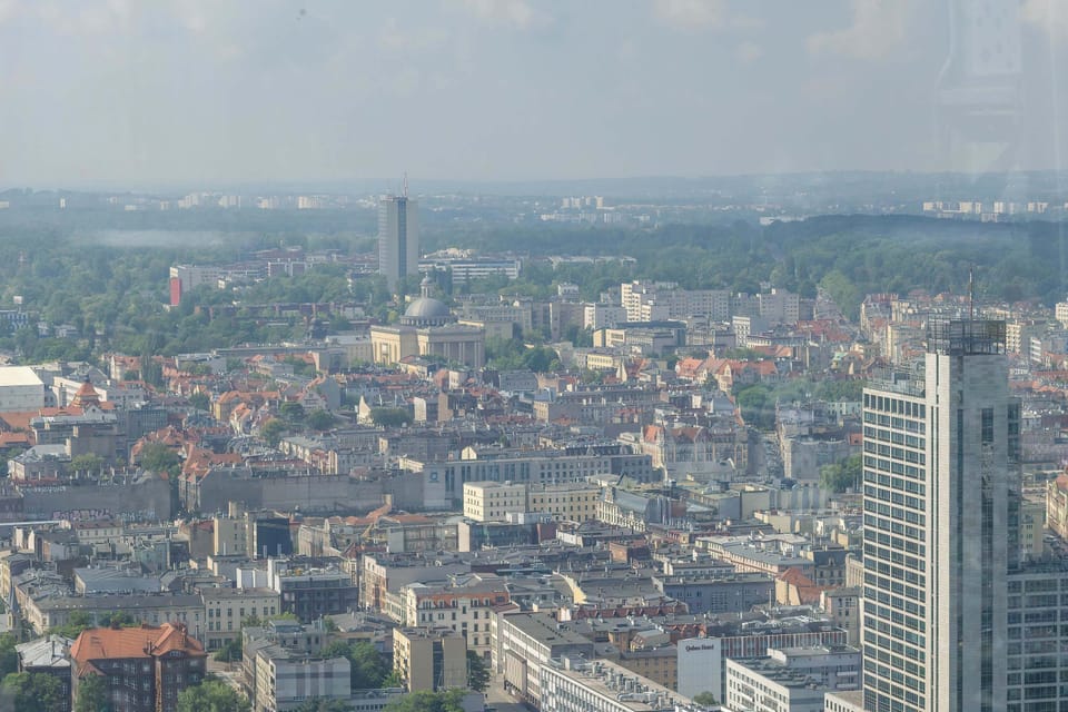 Another expansive city view from a high vantage point captures the dense urban layout, featuring a mix of residential buildings and prominent landmarks in the distance.