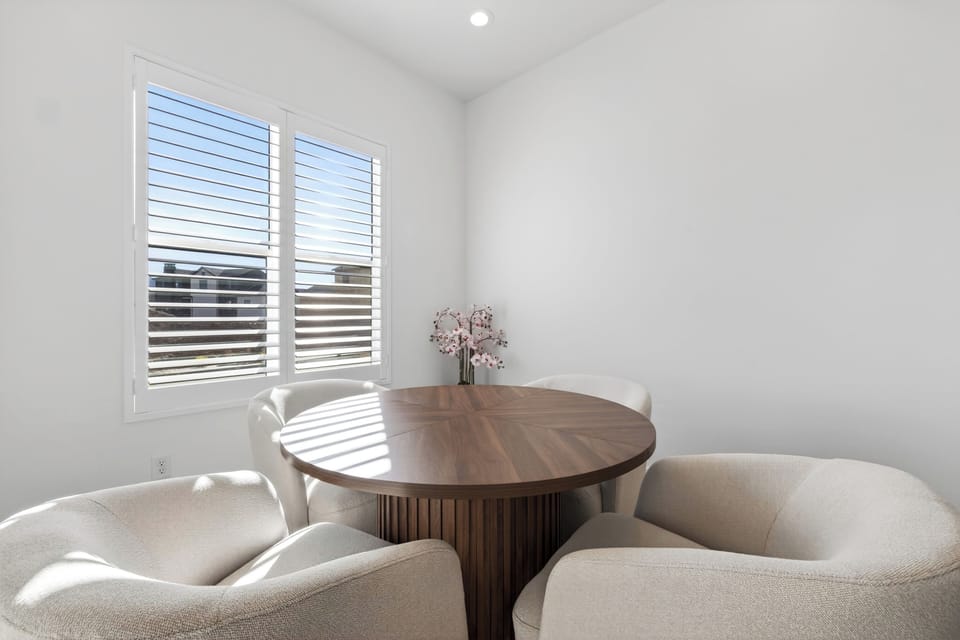 Separate dining nook with cozy swivel chairs—perfect for morning coffee, games, or quiet conversations.