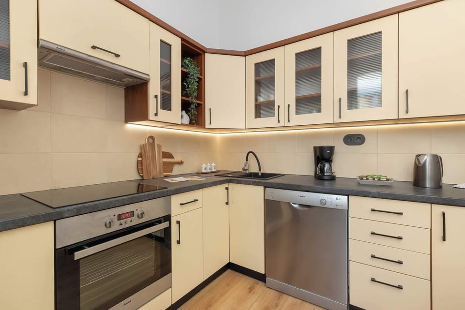 A spacious kitchen with ample storage and countertop space. The room combines functionality with a modern design.