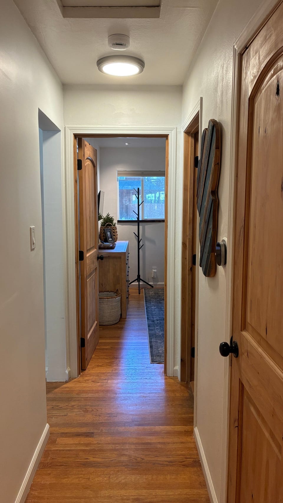 Kitchen sink area with coffee station, toaster, window, counter, open shelf, and everyday prep space.