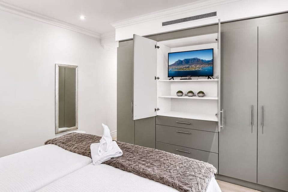 Comfortable Guest Bedroom: A calm and functional retreat featuring smart storage, modern conveniences, and a restful atmosphere for a relaxing stay.