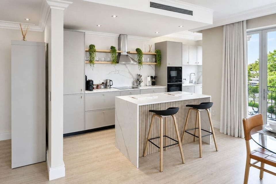 Designer Kitchen: Prepare meals and gather with ease in a beautifully appointed kitchen featuring premium finishes, abundant natural light, and a welcoming open-plan layout.