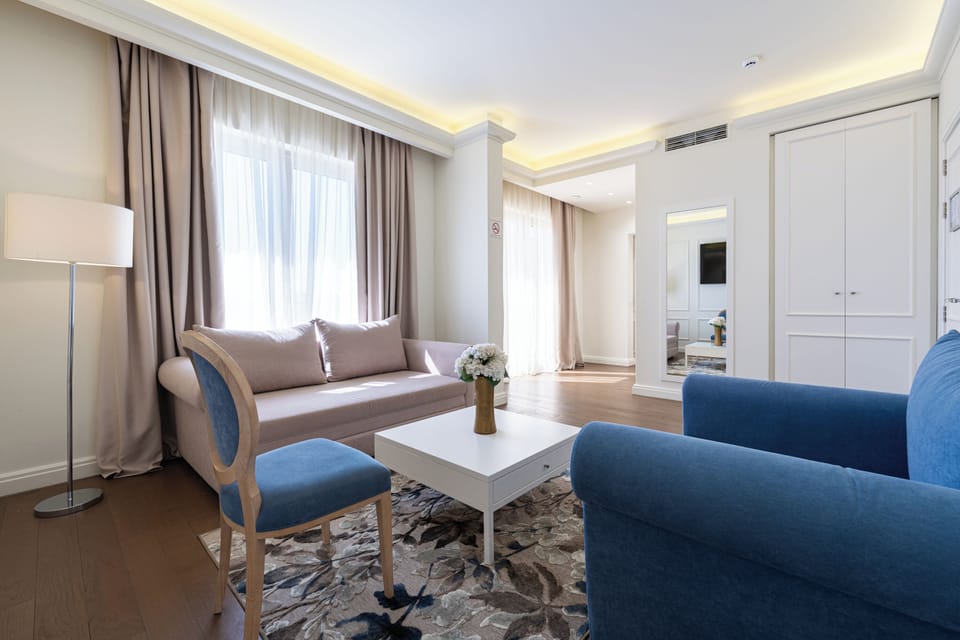 Deluxe Apartment | Living area | 50-inch Smart TV with satellite channels