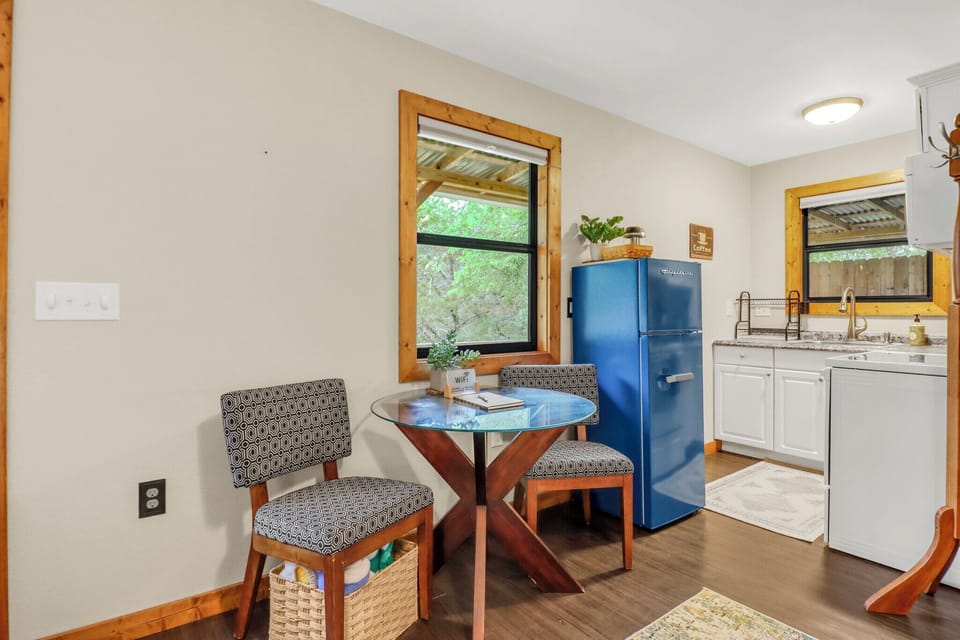 Cozy dining nook where you can enjoy morning coffee while gazing at peaceful garden views. Bright, open space flows seamlessly into your fully-equipped kitchen, ready for meal prep.