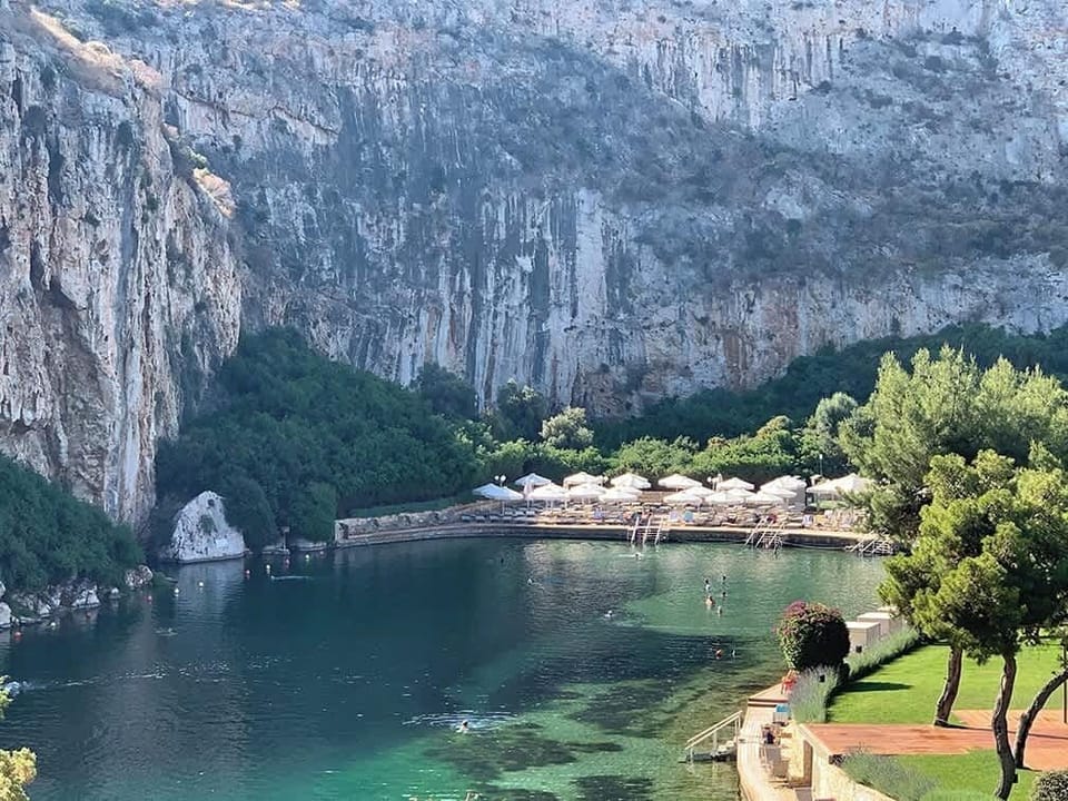 Scenic Lake Vouliagmeni and Coastal Cliffs Nearby
