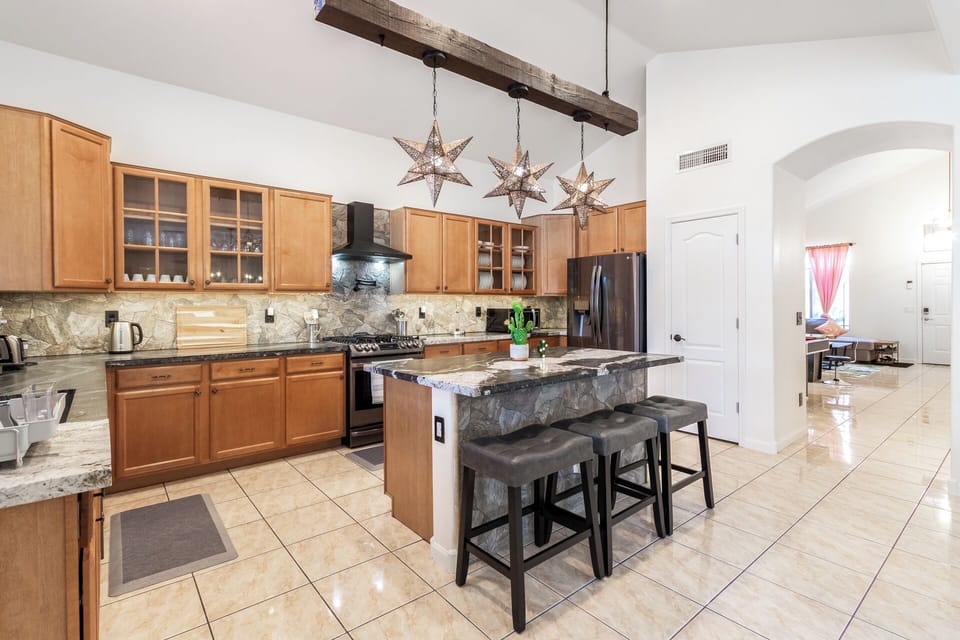 Oversized island seating makes meal prep, conversation, and morning coffee easy.