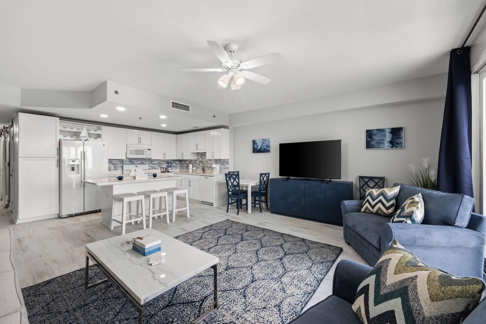 Relax in your stylish open-concept space with a fully equipped kitchen, modern living area, and coastal-inspired décor—perfect for unwinding after a day exploring.
