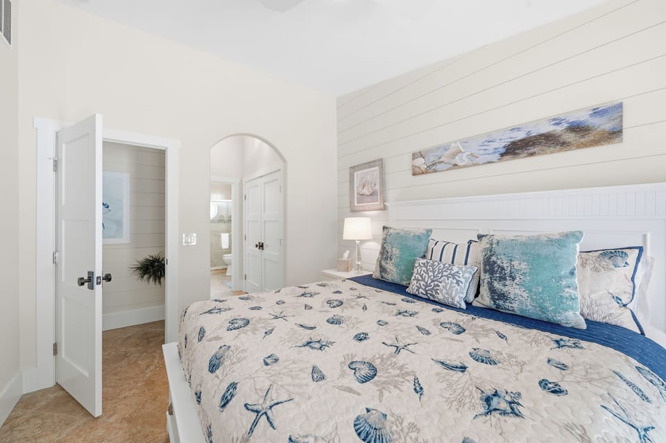 Slip into your cozy coastal retreat where gentle sea blues and soft linens invite restful nights. Your own beachside haven awaits with calming décor and an ensuite just steps away.