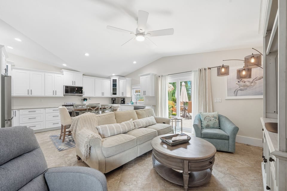 Unwind in your bright, open living space with plush seating, modern kitchen, and coastal charm—perfect for memorable gatherings with loved ones.