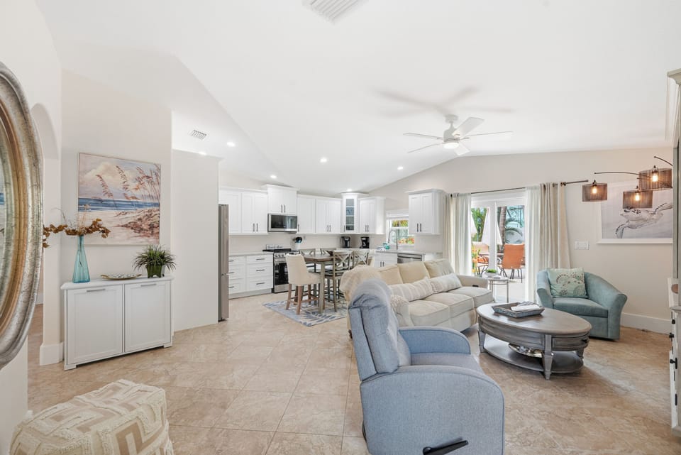 Settle into your bright, airy open-concept living space where soft coastal tones and beach-inspired artwork invite relaxation. Your fully equipped kitchen flows seamlessly into a cozy lounge, perfect for unwinding after sunny island adventures.