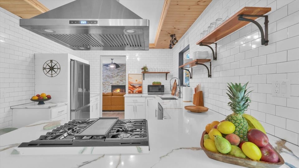 Fully equipped kitchen with a large fridge, stove, oven, microwave, and everything you need for your stay.