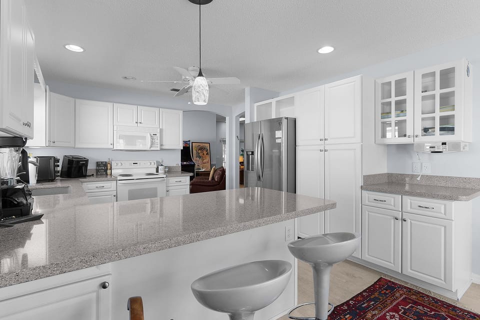 Your gourmet kitchen features gleaming granite countertops, modern stainless appliances, and ample cabinet space—perfect for preparing meals and gathering with loved ones during your stay.