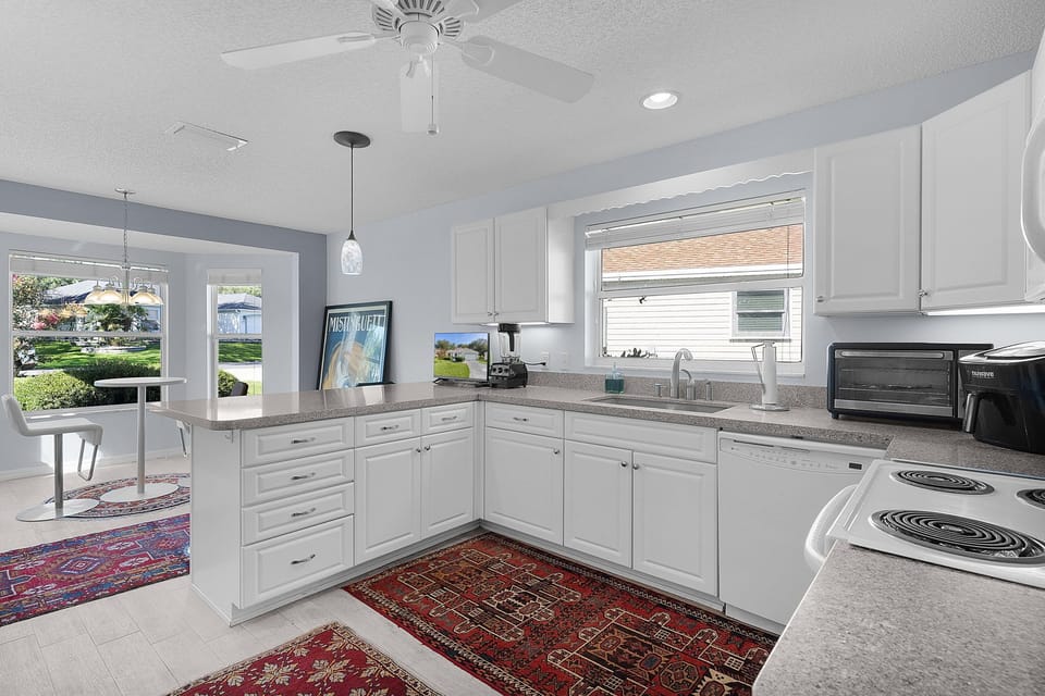This bright, open kitchen is perfect for preparing your favorite meals, with ample counter space, modern appliances, and beautiful natural light streaming through the windows.