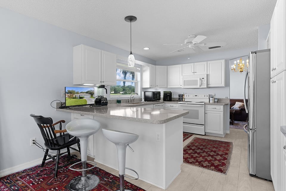 Your fully equipped kitchen features granite countertops, modern appliances, and a convenient breakfast bar where you can sip morning coffee while planning the day's adventures.