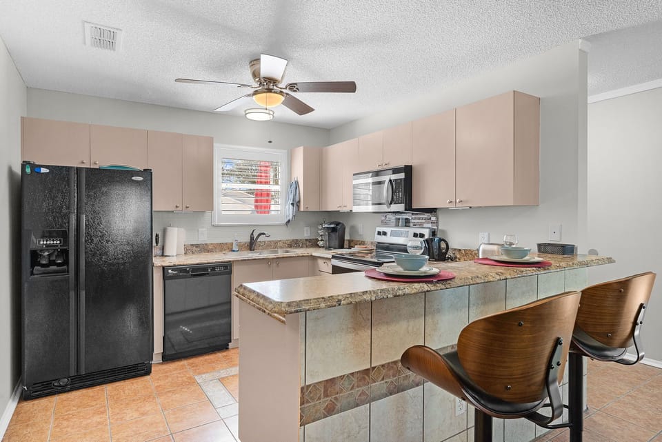 Your fully equipped kitchen awaits with granite countertops, modern appliances, and a breakfast bar perfect for casual meals or morning coffee with friends and family.