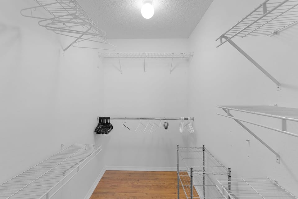 Spacious walk-in closet with ample shelving, hanging rods, and storage options to keep your wardrobe organized throughout your stay.