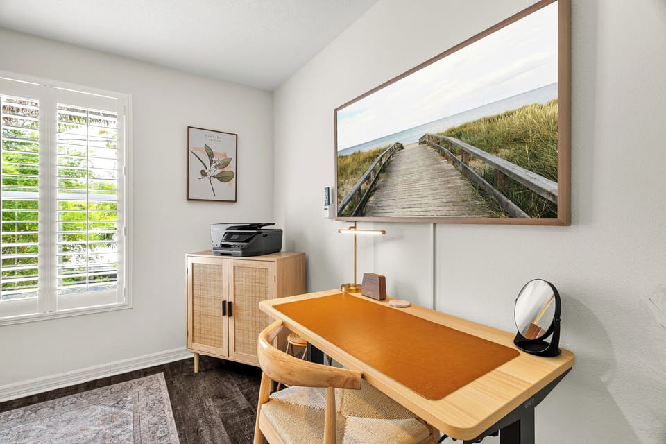 Picture yourself working from this serene, sun-filled space with coastal charm at your fingertips. Natural light flows through the windows, setting a calm, focused mood for your remote workdays.