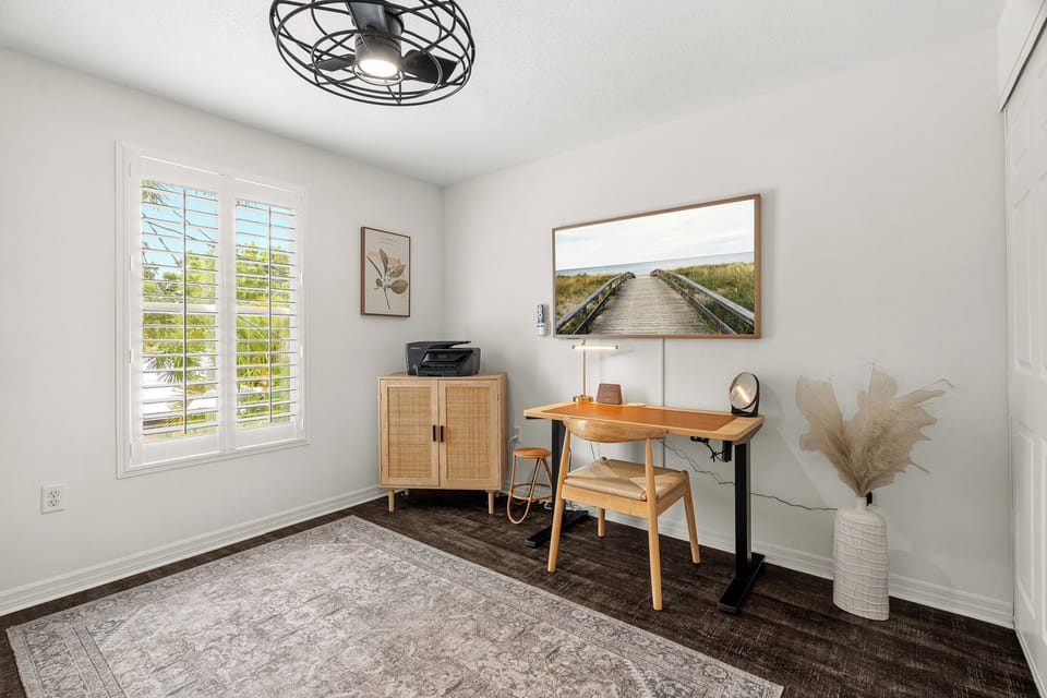 Your tranquil workspace awaits, complete with natural light from shuttered windows, inspiring artwork, and a dedicated desk—perfect for balancing work and relaxation during your stay.