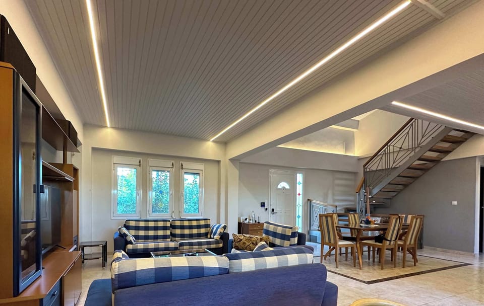 A spacious lounge area with large seating arrangements and recessed lighting creates a relaxed setting for spending time together indoors.