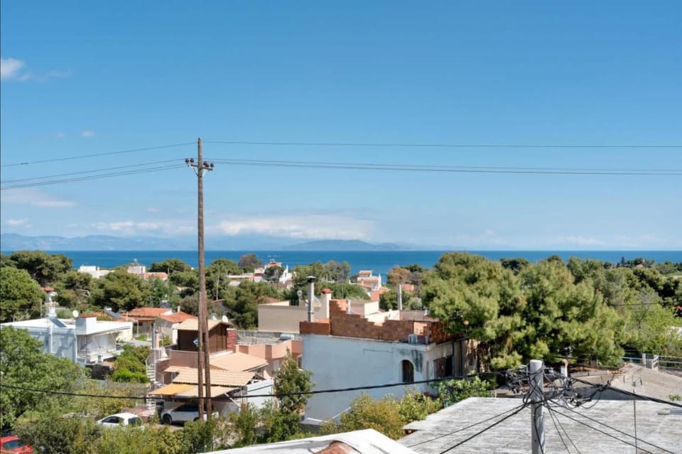 Open views across Artemida stretch towards the coastline, offering a sense of space and connection to the surrounding landscape from the upper level terraces.