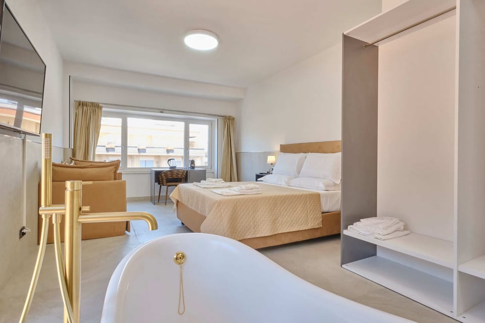 Deluxe Triple Room, City View | In-room safe, laptop workspace, blackout drapes, soundproofing