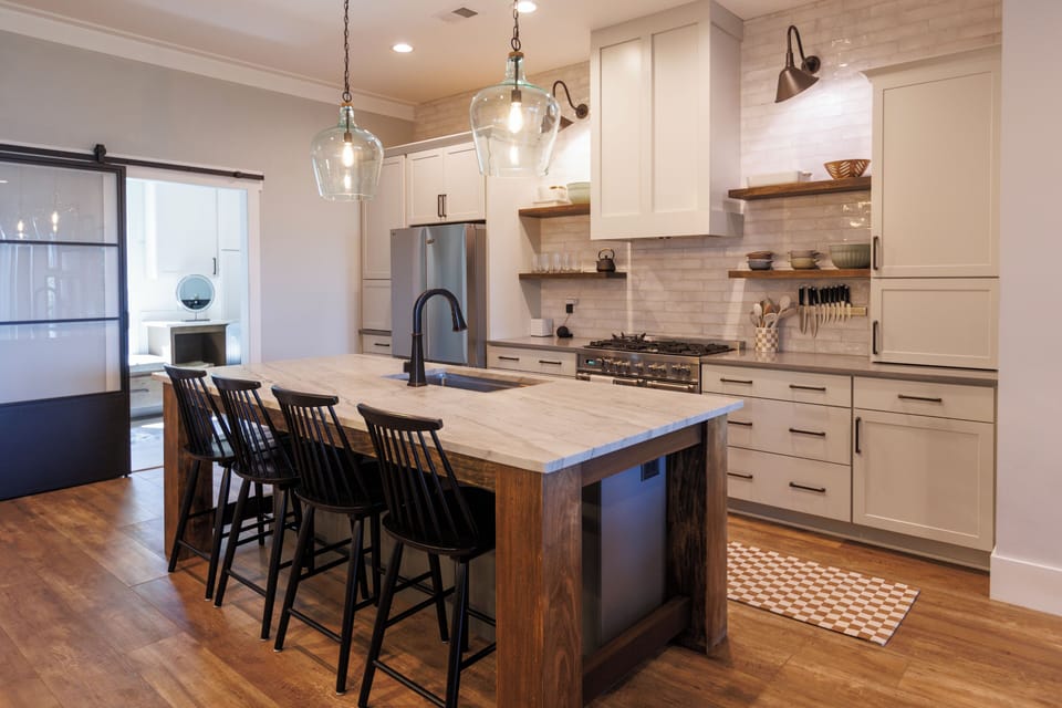 Gallery wall of mountain prints by the kitchen island and bar seating