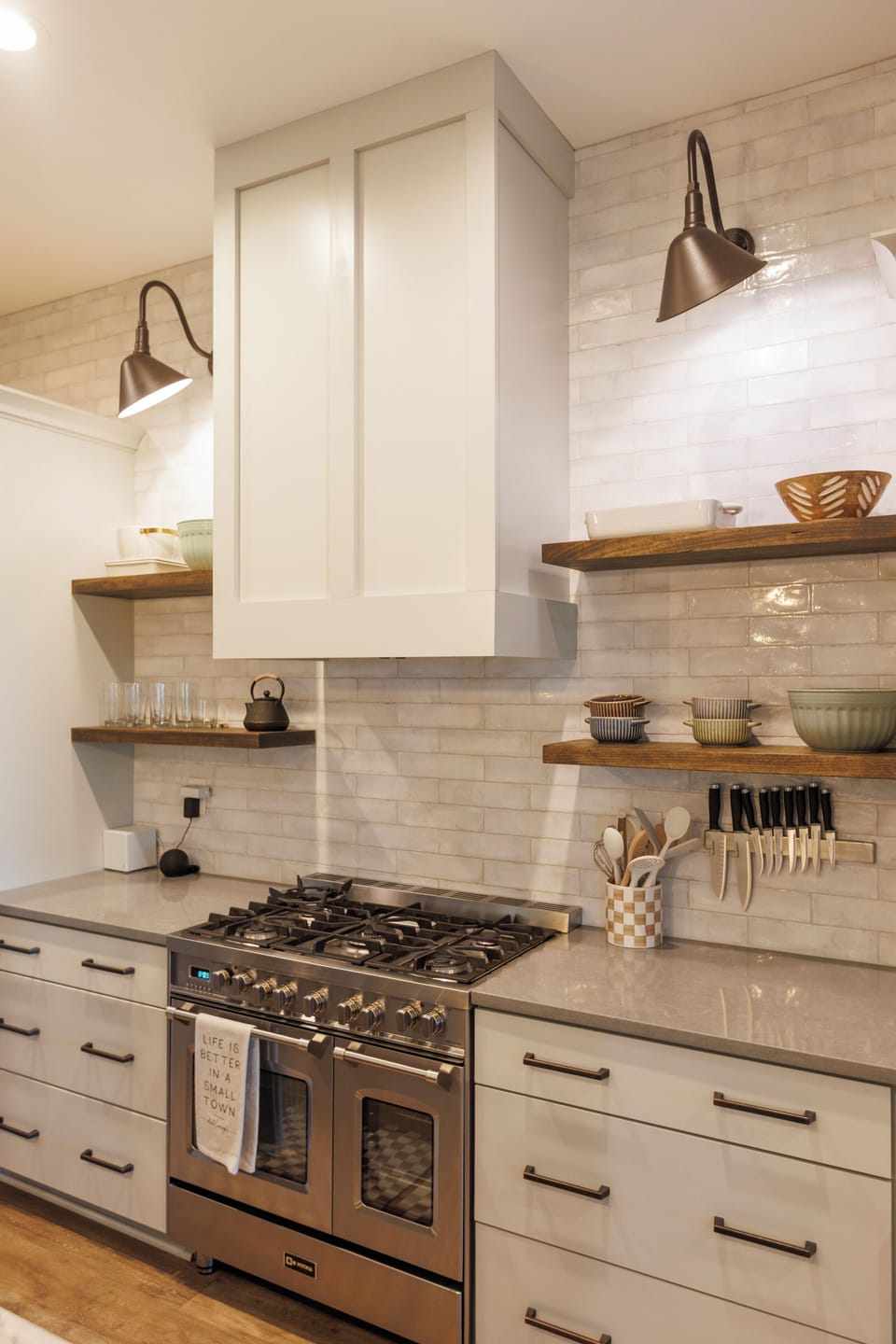 Chef's kitchen with a marble island, 6-burner gas range, and bar seating